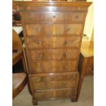 A 20th century yew wood chest on chest in two parts of small size with an arrangement of drawers