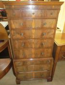 A 20th century yew wood chest on chest in two parts of small size with an arrangement of drawers