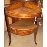 A George III mahogany corner washstand with cross banding and inlaid decoration having two tiers on