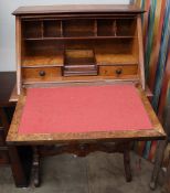 An early 20th century walnut bureau with a sloping fall and fitted interior