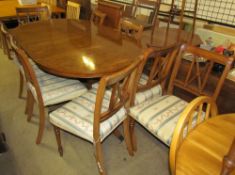 A Regency yew wood twin pillar dining table with a cross-banded top including an extra leaf on two