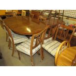 A Regency yew wood twin pillar dining table with a cross-banded top including an extra leaf on two