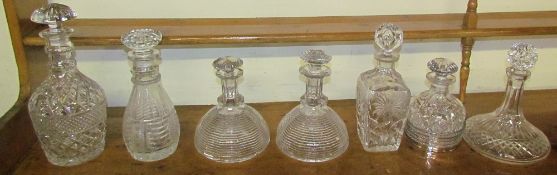 A pair of 19th century cut glass decanters together with five other decanters and an electroplated