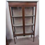 An Edwardian mahogany display cabinet, the rectangular top above a marquetry frieze,