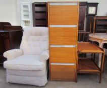 A teak tea trolley together with a filing cabinet and a reclining chair