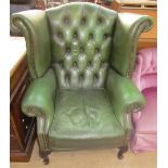 A green leather wingback armchair
