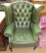 A green leather wingback armchair