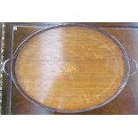 An oak tray of oval form with a central fan spandrel to a pierced electroplated gallery on ball