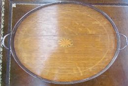 An oak tray of oval form with a central fan spandrel to a pierced electroplated gallery on ball