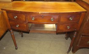 A late Regency mahogany bow front dressing table, having five drawers about a kneehole,