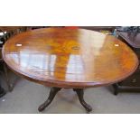 A Victorian walnut supper table of oval form on four legs