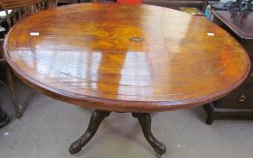 A Victorian walnut supper table of oval form on four legs