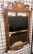 A George III style mahogany fret carved wall mirror with satinwood fan inlay to the crest and below,