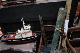 A model of a tug together with a fishing rod,