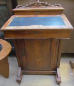 A Victorian walnut davenport desk with a raised stationery section,