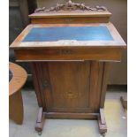 A Victorian walnut davenport desk with a raised stationery section,