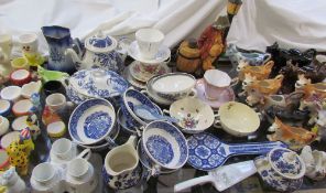 A moulded porcelain part tea set together with cow creamers, tea cups and saucers,