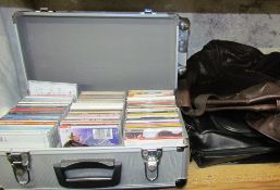 A brown leather holdall together with a black leather suit carrier,