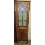 A Georgian style yew wood standing corner cupboard,