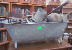 A tin bath together with a large quantity of tin watering cans, pails, jugs,