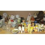 A collection of pottery egg cups together with novelty tea pots, commemorative mugs, jugs,