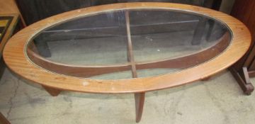 A mid-20th century teak and glass elliptical coffee table