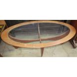 A mid-20th century teak and glass elliptical coffee table