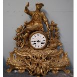 A gilt metal mantle clock with a figural surmount,