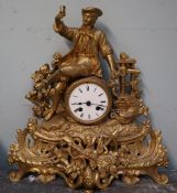 A gilt metal mantle clock with a figural surmount,