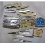 Silver bladed and mother of pearl pocket knives together with other pocket knives and tape