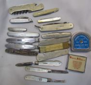 Silver bladed and mother of pearl pocket knives together with other pocket knives and tape