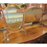 A Victorian mahogany shield shaped toilet mirror together with an oval toilet mirror on ring turned