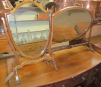 A Victorian mahogany shield shaped toilet mirror together with an oval toilet mirror on ring turned