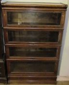 An oak four division Globe-Wernicke bookcase with glazed doors and a drawer to the base