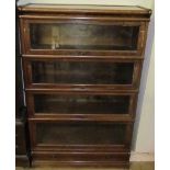 An oak four division Globe-Wernicke bookcase with glazed doors and a drawer to the base