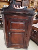 An 18th century oak hanging corner cupboard with a twin panelled front together with another