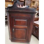 An 18th century oak hanging corner cupboard with a twin panelled front together with another