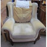 An upholstered wing back armchair