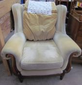 An upholstered wing back armchair