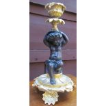 A gilt metal cherub candlestick