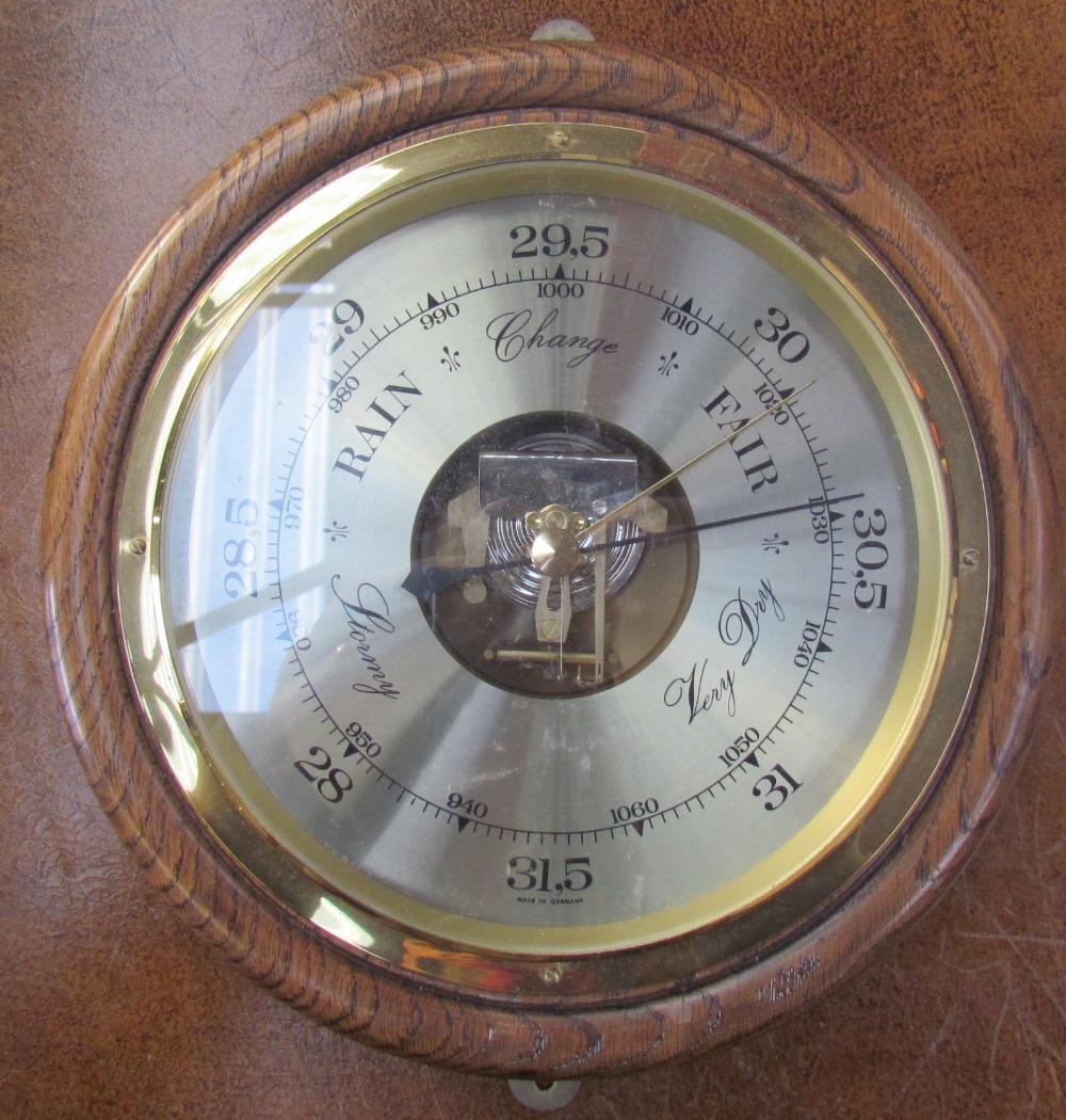 An oak cased aneroid barometer of circular form