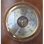 An oak cased aneroid barometer of circular form