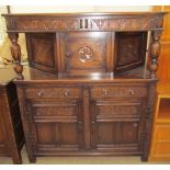 A 20th century oak court cupboard the rectangular top above a pair of drawers and a central