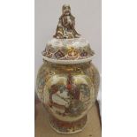 A Japanese Satsuma pottery vase, with a seated dignitary to the domed lid,