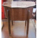 An oak sewing table with a shaped top on square legs
