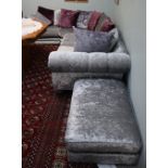 A silver and purple upholstered corner suite and matching foot stool
