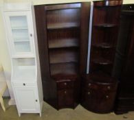 Two Beresford and Hicks reproduction mahogany standing corner cupboards together with a white wall