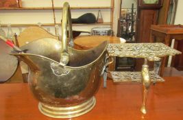 A Brass footman with a pierced top and shelf on cabriole legs together with a brass coal scuttle,