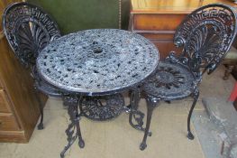 A black painted garden table and chairs