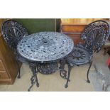 A black painted garden table and chairs